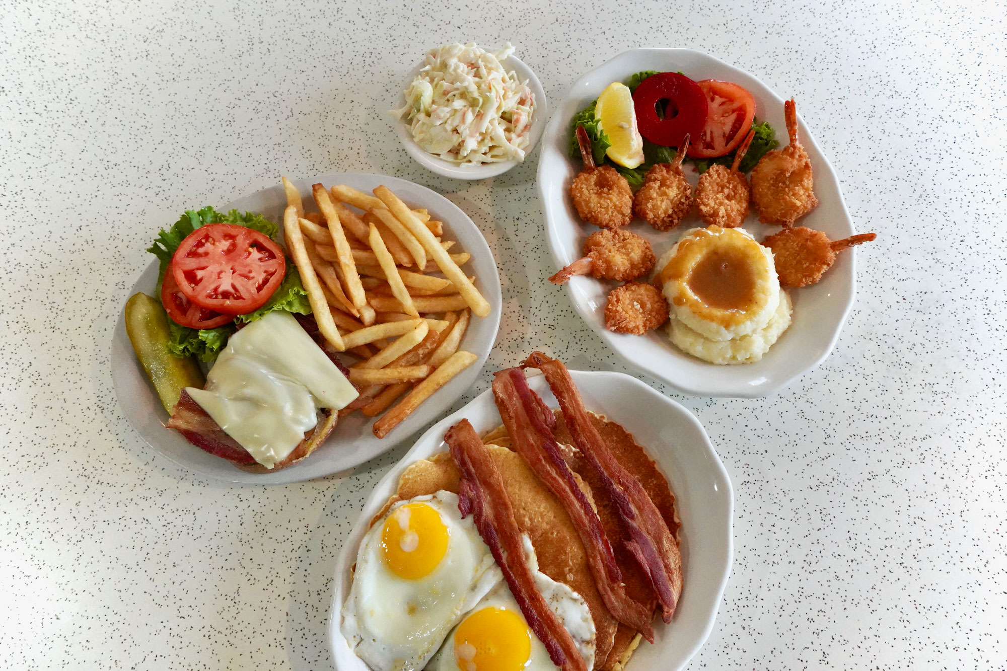 Cheese burger, fries, bacon and eggs, fried shrimp